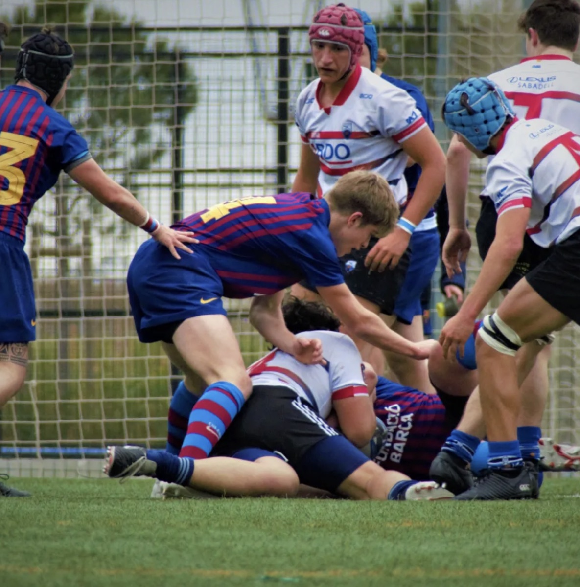 Àlex Català playing rugby — making a tackle